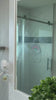 Woman cleaning shower glass and bathroom mirror with dancemoon JustHang shower squeegee